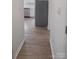 Hallway leading to a modern kitchen, featuring stainless steel appliances at 401 Woodlawn Ave, Cramerton, NC 28032