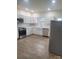 Bright kitchen featuring stainless steel appliances, stylish countertops, and modern white cabinets at 401 Woodlawn Ave, Cramerton, NC 28032