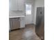 Renovated kitchen with stainless steel appliances, white cabinets, and wood flooring at 401 Woodlawn Ave, Cramerton, NC 28032