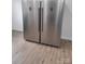 Side by side stainless steel refrigerators on wood-look floors in the kitchen at 401 Woodlawn Ave, Cramerton, NC 28032