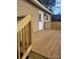 Wooden deck on a home featuring beige siding and new railing at 401 Woodlawn Ave, Cramerton, NC 28032