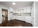 Bright kitchen with white cabinets, modern backsplash, and view to an adjacent living area at 2186 W Nc 10 Hwy, Newton, NC 28658