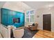 Relaxing sitting area with built-in teal cabinets and hardwood floor at 2526 Normandy Rd, Charlotte, NC 28209