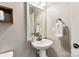 Small bathroom with pedestal sink and white vanity at 2844 Georgia Ave, Charlotte, NC 28205