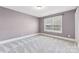 Simple bedroom with neutral colored walls and carpet at 2844 Georgia Ave, Charlotte, NC 28205