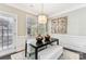 Elegant dining area with hardwood floors, a black table and bench seating at 2844 Georgia Ave, Charlotte, NC 28205