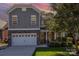 Two-story home with gray siding, stone accents, and a two-car garage at 2844 Georgia Ave, Charlotte, NC 28205