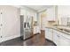 Kitchen features stainless steel refrigerator and white cabinets at 2844 Georgia Ave, Charlotte, NC 28205