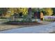 Picturesque backyard featuring a storage shed, a stone garden, and mature trees for privacy at 4000 Wilson Ln, Charlotte, NC 28206