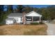 Charming backyard with a covered patio, perfect for outdoor dining and relaxation at 4000 Wilson Ln, Charlotte, NC 28206