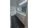 Modern bathroom features double sink vanity with marble countertop, and gray tiled floor at 4000 Wilson Ln, Charlotte, NC 28206