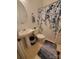 Well-lit bathroom featuring a pedestal sink and a shower with a floral curtain at 4000 Wilson Ln, Charlotte, NC 28206