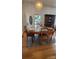 Charming dining room area with glass table, hardwood floors, and views to front yard at 4000 Wilson Ln, Charlotte, NC 28206