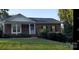 Charming single-story brick home with a well-manicured lawn and inviting front porch at 4000 Wilson Ln, Charlotte, NC 28206