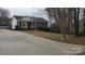Traditional brick home with a welcoming front porch and a long driveway at 4000 Wilson Ln, Charlotte, NC 28206