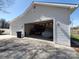 Exterior view of a three car garage with car lifts and ample storage space, perfect for automotive enthusiasts at 4000 Wilson Ln, Charlotte, NC 28206