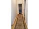 Hallway with light wood floors and a decorative rug leading to the bathroom at 4000 Wilson Ln, Charlotte, NC 28206