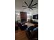 Spacious living room featuring a brick fireplace, hardwood floors and modern ceiling fan at 4000 Wilson Ln, Charlotte, NC 28206
