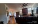 Open concept living and dining area with hardwood floors and brick fireplace at 4000 Wilson Ln, Charlotte, NC 28206