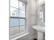 Modern bathroom features a pedestal sink, an oval mirror and a large window at 613 Hops Aly, Fort Mill, SC 29715