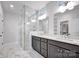 Modern bathroom with dual vanity, marble countertop, and glass enclosed shower at 613 Hops Aly, Fort Mill, SC 29715