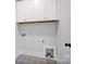 Bright laundry room features stylish patterned floors, white cabinetry, and modern fixtures at 613 Hops Aly, Fort Mill, SC 29715