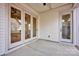 Covered patio area with white siding, concrete floor, and access doors to the home at 613 Hops Aly, Fort Mill, SC 29715