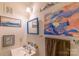 Small bathroom with a sink, mirror, and artistic wall decor at 3722 Park Rd # Q, Charlotte, NC 28209