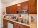 Wood kitchen cabinets, double sink, and ample counter space at 3722 Park Rd # Q, Charlotte, NC 28209
