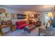 Bright living room with a red sofa and a view into another room at 3722 Park Rd # Q, Charlotte, NC 28209