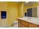Bathroom featuring bright yellow walls, textured surface, a vanity, and toilet at 1652 12Th Ne St, Hickory, NC 28601
