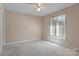 Neutral bedroom features soft carpet, natural light, and a ceiling fan at 1652 12Th Ne St, Hickory, NC 28601