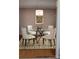 Elegant dining area features a modern chandelier, round glass table, and stylish chairs at 1652 12Th Ne St, Hickory, NC 28601