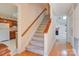 Entryway showcasing staircase, wood flooring, kitchen glimpse and lots of natural light in a well-kept home at 1652 12Th Ne St, Hickory, NC 28601