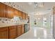 Well-lit kitchen with oak cabinets, stainless steel dishwasher, and floral wallpaper at 1652 12Th Ne St, Hickory, NC 28601