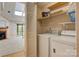 Clean, well-lit laundry room features a skylight, washer, dryer, and storage shelves at 1652 12Th Ne St, Hickory, NC 28601