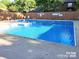 Community swimming pool with clear blue water, surrounded by a wooden fence at 1652 12Th Ne St, Hickory, NC 28601
