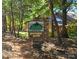 Stone sign for Huntington Woods neighborhood nestled among mature trees at 1652 12Th Ne St, Hickory, NC 28601
