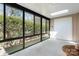 Bright sunroom with large windows offering scenic views, white carpet, and door for easy access at 1652 12Th Ne St, Hickory, NC 28601