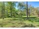 Expansive, well-maintained backyard features mature trees and lush green grass, perfect for outdoor activities at 1652 12Th Ne St, Hickory, NC 28601