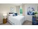 Bright bedroom with a white bed, blue accents, a view, and beige carpeting at 3880 Maxwell Henry Nw Ln, Conover, NC 28613