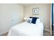Clean and bright bedroom with a white bed, blue pillows, and a side table with a lamp at 3880 Maxwell Henry Nw Ln, Conover, NC 28613