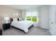 Bright bedroom featuring large window overlooking green space, neutral walls, and plush carpet at 3880 Maxwell Henry Nw Ln, Conover, NC 28613