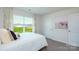 Cozy bedroom featuring a plush bed, soft carpet, a large window, and neutral decor at 3880 Maxwell Henry Nw Ln, Conover, NC 28613