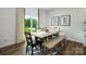 Dining area with a wooden table, stylish seating, and a sliding glass door to the backyard at 3880 Maxwell Henry Nw Ln, Conover, NC 28613
