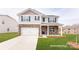 Two-story home featuring stone accents, a covered porch, and a well-manicured lawn at 3880 Maxwell Henry Nw Ln, Conover, NC 28613