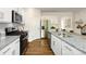 Well-lit kitchen showcasing granite countertops, stainless steel appliances, and hardwood flooring at 3880 Maxwell Henry Nw Ln, Conover, NC 28613