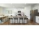Bright, open kitchen with granite countertops, breakfast bar, and stainless steel refrigerator at 3880 Maxwell Henry Nw Ln, Conover, NC 28613