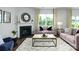 Cozy living room featuring a fireplace, plush seating, and a large window at 3880 Maxwell Henry Nw Ln, Conover, NC 28613