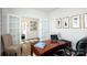 Well-lit home office with a wooden desk, comfortable seating, and stylish decor at 3880 Maxwell Henry Nw Ln, Conover, NC 28613